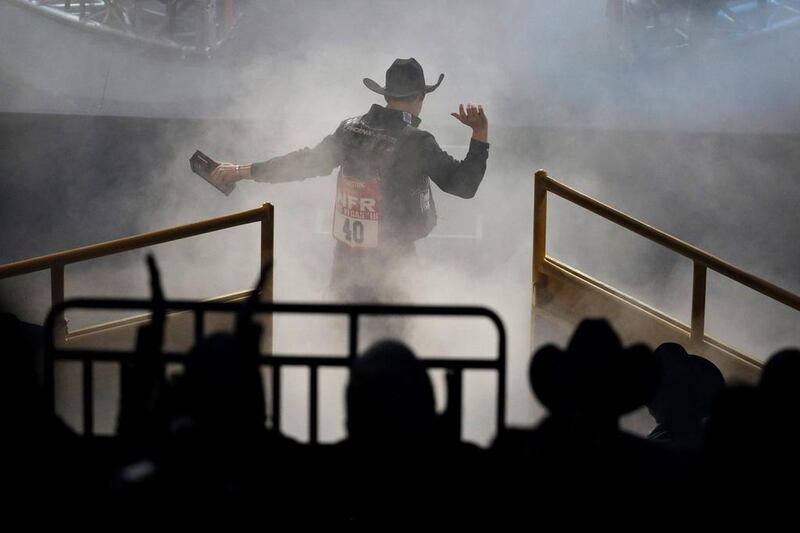 Saddle bronc world champion Zeke Thurston celebrates as the takes the stage on the final night of the National Finals Rodeo, in Las Vegas. John Locher / AP