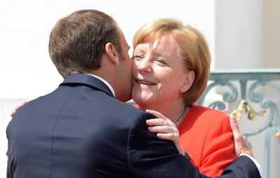 France's President Emmanuel Macron is welcomed by German Chancellor Angela Merkel in the guest house of the German government in Meseberg north of Berlin, Germany, Tuesday, June 19, 2018. (AP Photo/Jens Meyer)