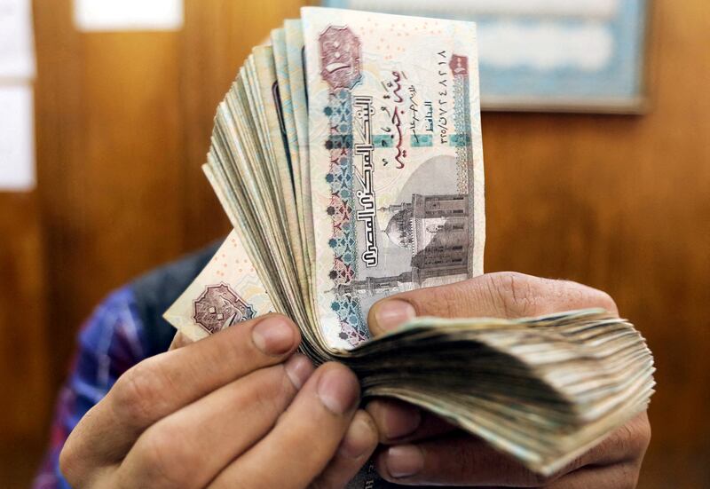 An employee counts Egyptian pounds at a foreign exchange office in central Cairo. Reuters