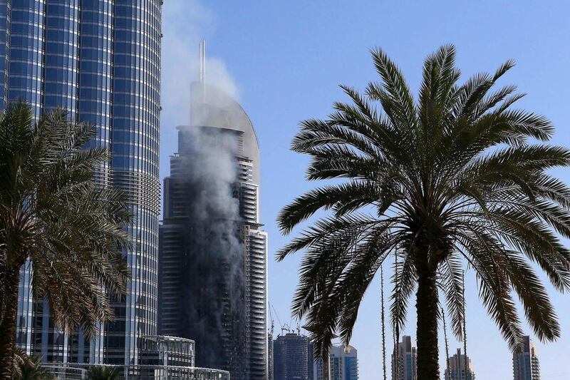 The fire at The Address Downtown Dubai hotel smolders on New Year's Day. Pawan Singh / The National 