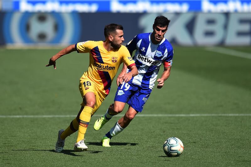 Barcelona defender Jordi Alba runs with the ball under pressure from Manu Garcia of Alaves. Getty Images