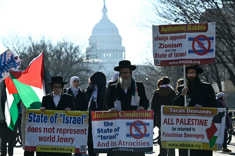 Members of the anti-Zionist Jews group Neturei Karta join pro-Palestinians people blocking a street close to the US Capitol in Washington. AFP