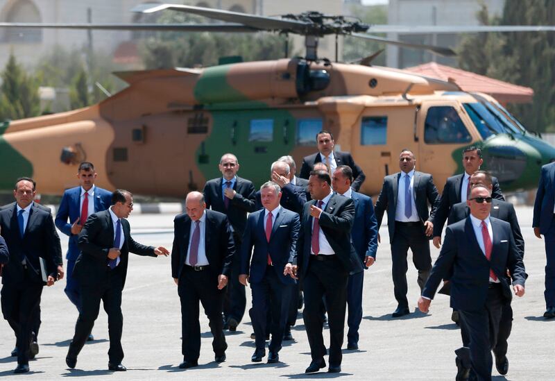 In his first visit to Mr Abbas's headquarters in Ramallah in five years, King Abdullah was welcomed on a red carpet near his helicopter by the Palestinian leader before the two national anthems were played. Abbas Momani / AFP Photo