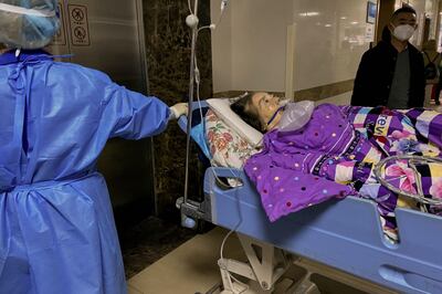 A Covid patient is taken to an emergency ward at Chongqing Medical University, south-western China. AFP