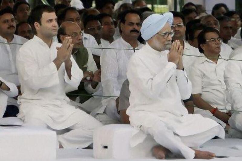 Congress party leader Rahul Gandhi, left, sits with Indian prime minister Manmohan Singh, at a prayer meeting to mark the death anniversary of his father and former Indian Prime Minister Rajiv Gandhi.