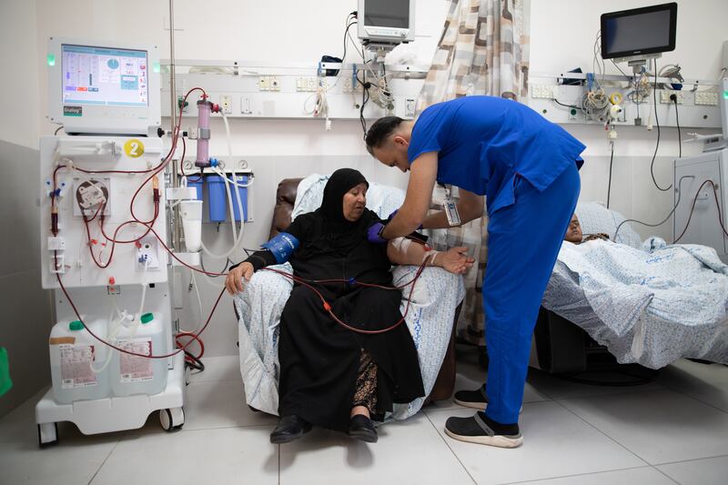 A medic prepares a patient from Gaza to receive dialysis treatment ​at Al Makassed Hospital in East Jerusalem. The UAE has signed a $25 million agreement to support the hospital, which provides health services to the Palestinian community. Corinna Kern for The National