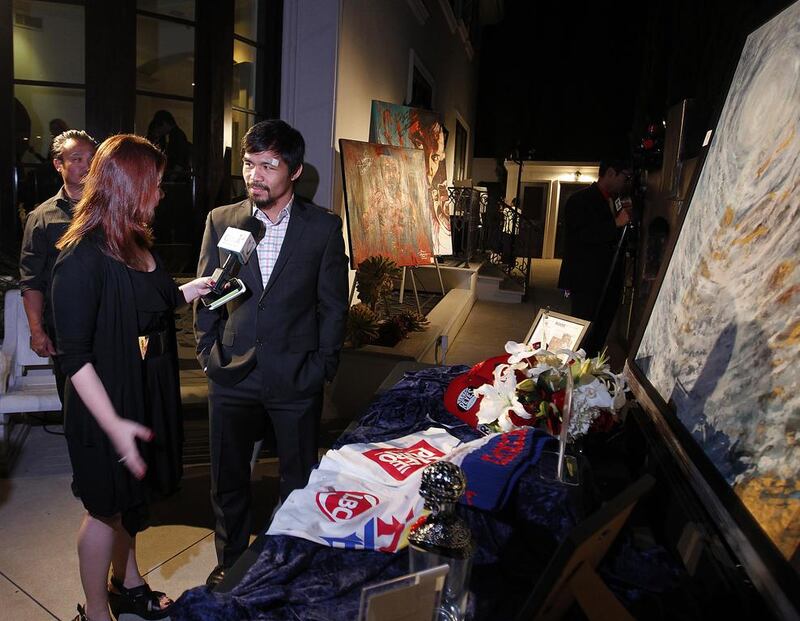 Manny Pacquiao attends a silent auction last year in Los Angeles, where he donated the boxing kit he wore against Timothy Bradley to raise funds for Typhoon Yolanda victims. Mike YOung for The National / April 15, 2014