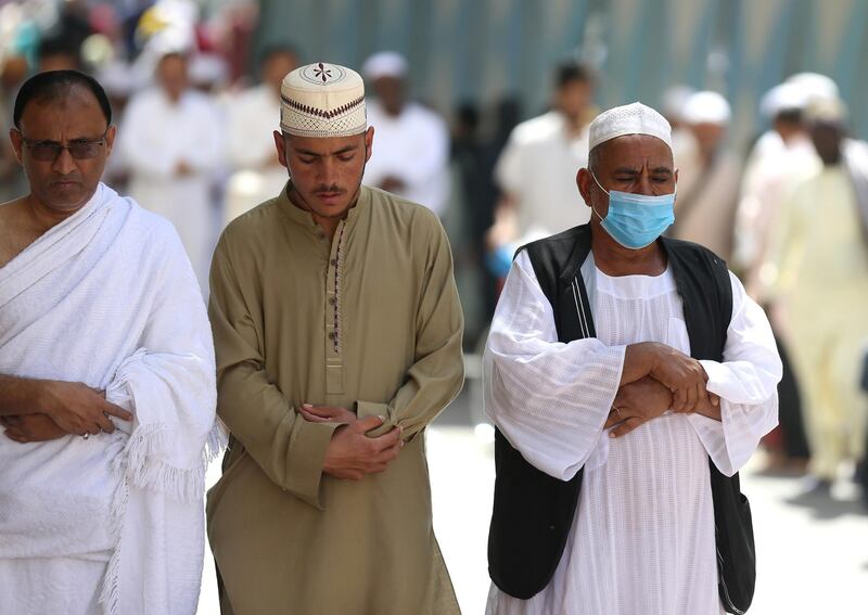 A muslim pilgrim wears a protective face mask to prevent contracting coronavirus, as he prays at the Grand mosque in the holy city of Mecca, Saudi Arabia. REUTERS