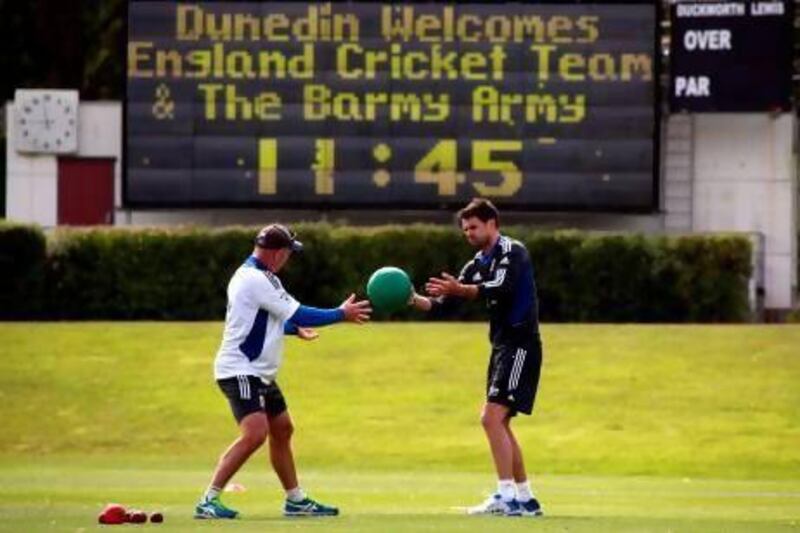 England cricket team player James Anderson, right, throws a ball to a team trainer during a cricket training session at the University Oval in Dunedin on Monday. England will play New Zealand in a three-Test series starting Wednesday. David Gray / Reuters