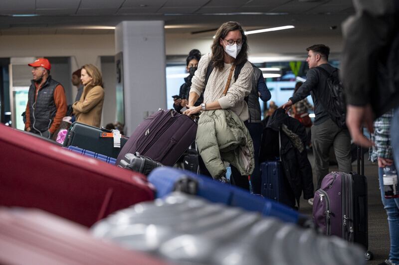 A traveller retrieves luggage at San Francisco International Airport in California on Tuesday.  Bloomberg