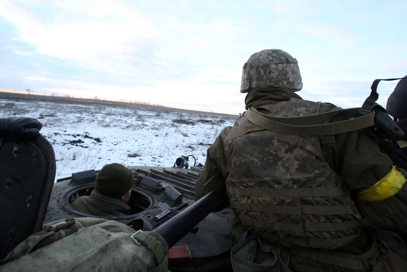 Ukrainian soldiers sit in their armoured vehicle after fighting against Russian troops and Russia-backed separatists near Zolote village, Luhansk region. AFP