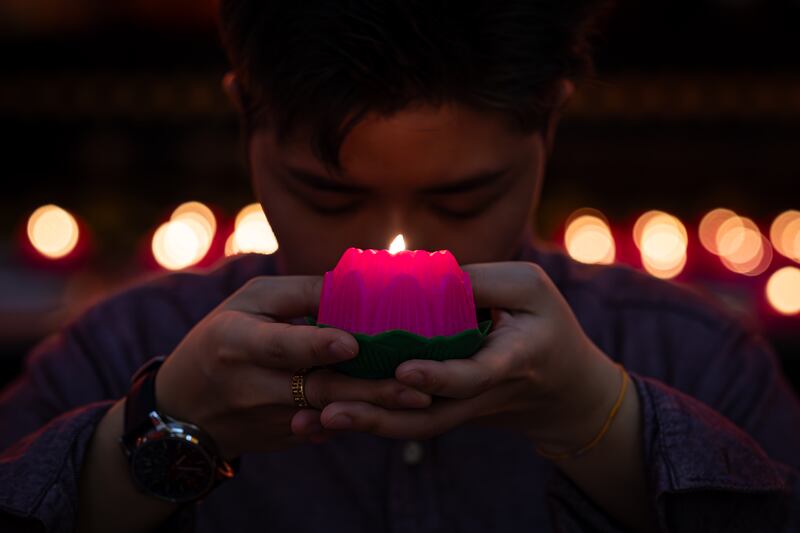 A Buddhist holds an oil lamp in a shape of a lotus flower as he offers prayers during a Lunar New Year celebration at Thean Hou Temple in Kuala Lumpur, Malaysia. Getty Images