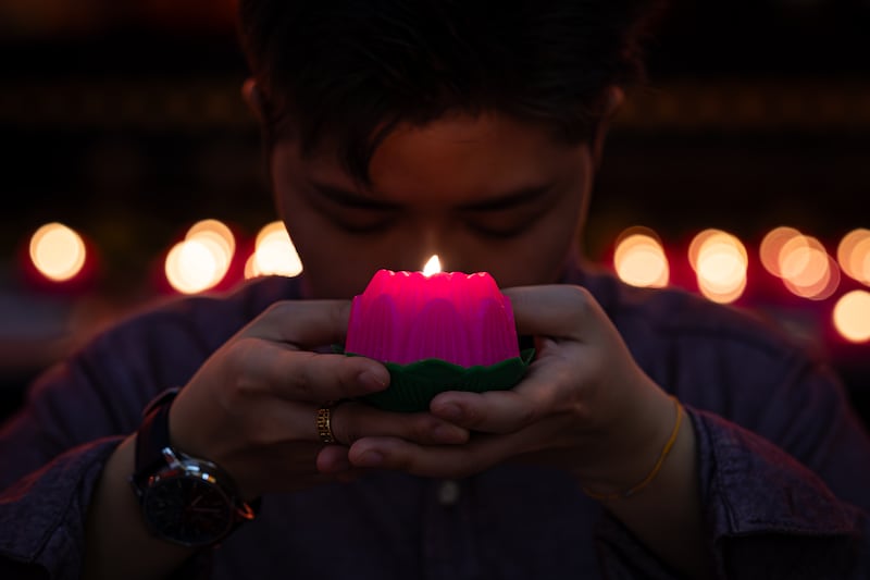 A Buddhist holds an oil lamp in a shape of a lotus flower as he offers prayers during a Lunar New Year celebration at Thean Hou Temple in Kuala Lumpur, Malaysia. Getty Images