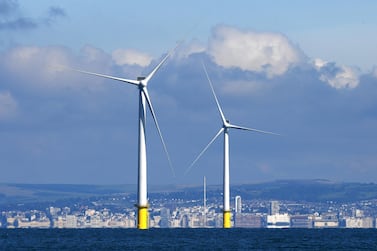 Wind turbines dominate the skyline off the coast of Brighton. The Confederation of British Industry says UK businesses can help to sustain the country's reputation as a global leader in offshore wind and the wider renewable energy sector. Getty Images