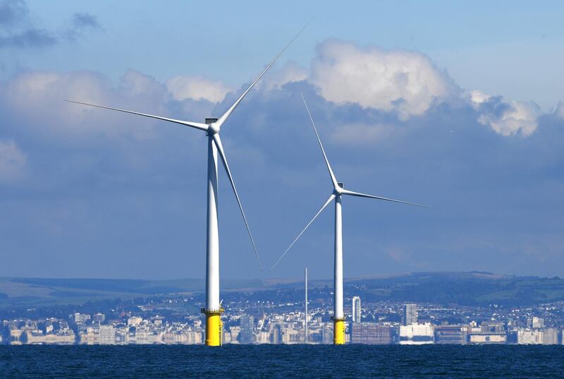 BRIGHTON, ENGLAND - SEPTEMBER 20:  Two of the 140m turbines dominate the skyline off the coast of Brighton on September 20, 2017 in Brighton, England.  The last of 116 wind turbines have been installed at the Rampion Offshore Wind Farm 13 kms off the Sussex Coast.  It will provide enough electricity to supply the equivalent of half the homes in Sussex.  (Photo by Mike Hewitt/Getty Images)