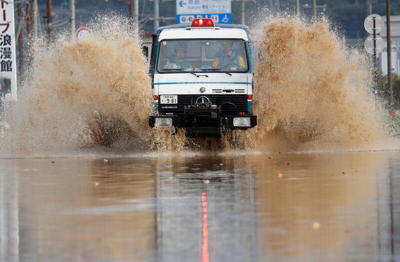 A rescue vehicle makes its way through a flooded area. Reuters