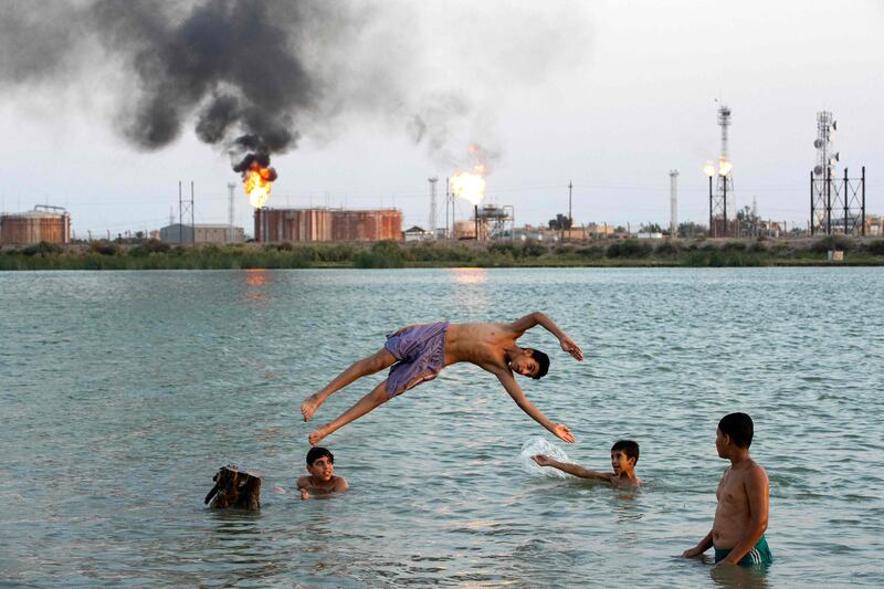 Iraqi youths swim in the Shatt al-Arab waterway at the end of a hot summer day in Basra. AFP