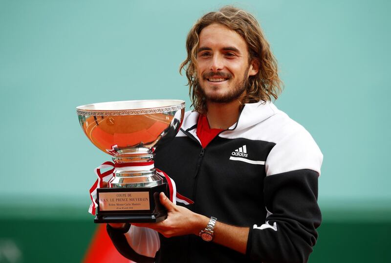 epa09143511 Stefanos Tsitsipas of Greece celebrates with the trophy after winning his final match against Andrey Rublev of Russia at the Monte-Carlo Rolex Masters tournament in Roquebrune Cap Martin, France, 18 April 2021.  EPA/SEBASTIEN NOGIER