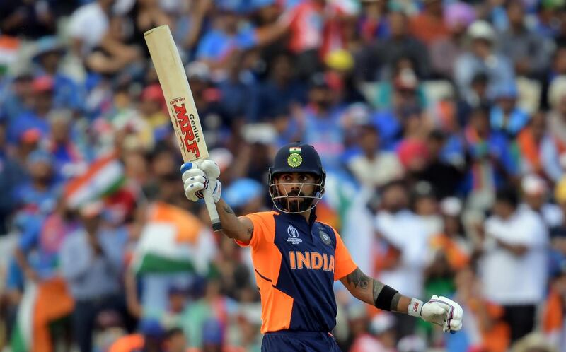 India's captain Virat Kohli celebrates after scoring a half-century (50 runs) during the 2019 Cricket World Cup group stage match between England and India at Edgbaston in Birmingham, central England, on June 30, 2019. (Photo by Dibyangshu Sarkar / AFP) / RESTRICTED TO EDITORIAL USE