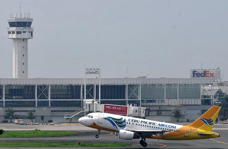 A Cebu Pacific plane takes off at the Ninoy Aquino International Airport in Manila. Pregnant women, children and those nearing the end of their stay on short term visas were among 325 passengers onboard a government-chartered repatriation flight from the UAE on Wednesday. Noel Celis / AFP