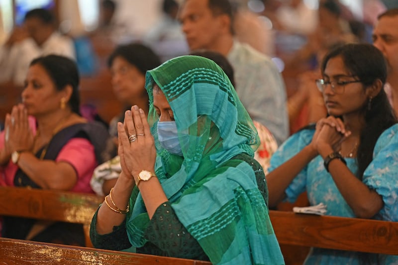 Christian devotees pray at a Christmas Mass in St. Patricks church in Chennai. AFP