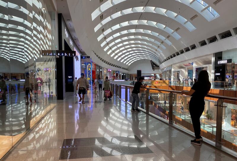 People wearing protective face masks shop at Dubai Mall after the UAE government eased restriction measures and allowed stores to open. Reuters