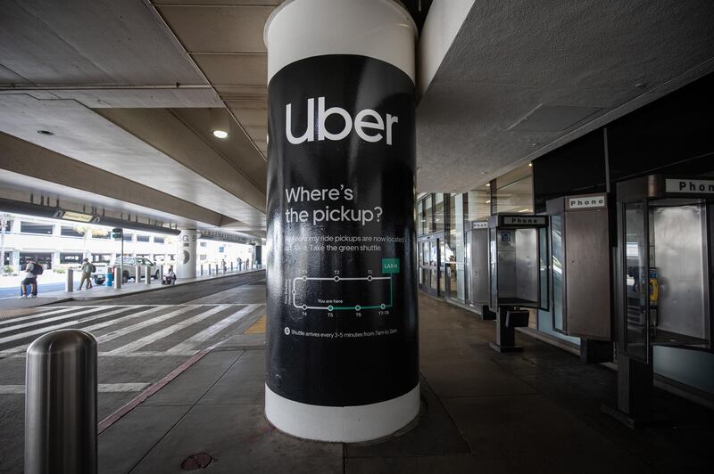 epa08600227 An ad for an Uber pickup station is seen at the Los Angeles International Airport in Los Angeles, California, USA, 12 August 2020. According to media reports, Uber is considering shuttering operations in California if forced to classify its drivers as employees. Drivers for the ride-hailing service are currently classified as independent contractors. A recent Superior Court ruling demanded the company classify its drivers as employees, as the current classification excludes them from access to workers compensation and health care benefits. Uber has filed an appeal against the ruling.  EPA/CHRISTIAN MONTERROSA