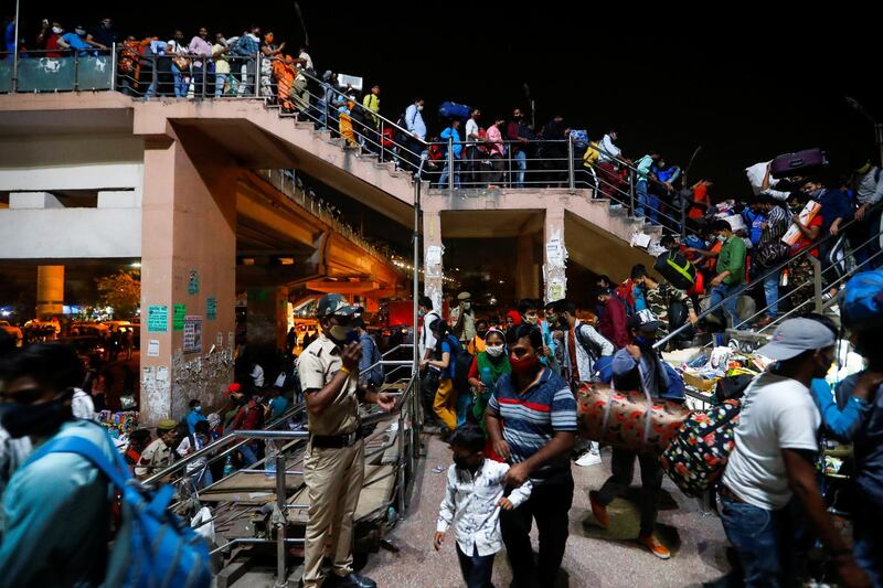 Migrant workers arrive at a bus station to return to their villages after Delhi government ordered a lockdown to limit the spread of the coronavirus. Reuters