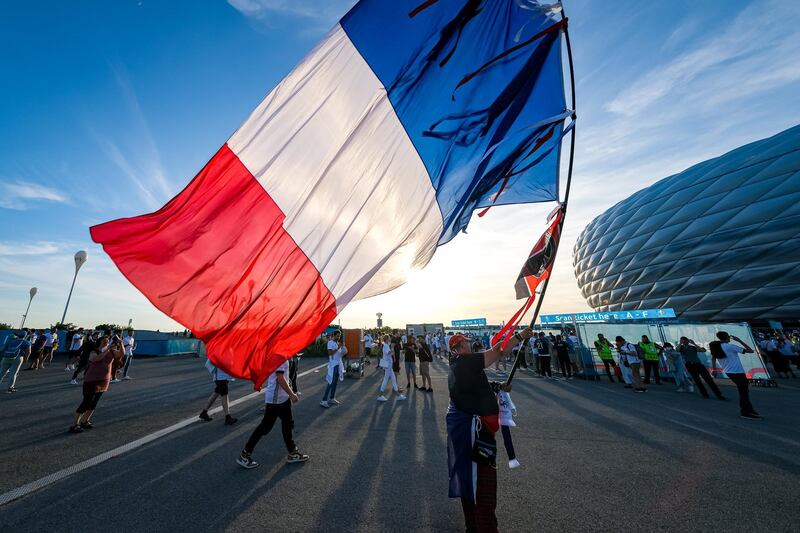 MUNICH, GERMANY - JUNE 15: A man carrying a huge French flag arrives ahead of the EURO 2020 Group F match between France and Germany at Allianz Arena on June 15, 2021 in Munich, Germany. (Photo by Leonhard Simon/Getty Images)