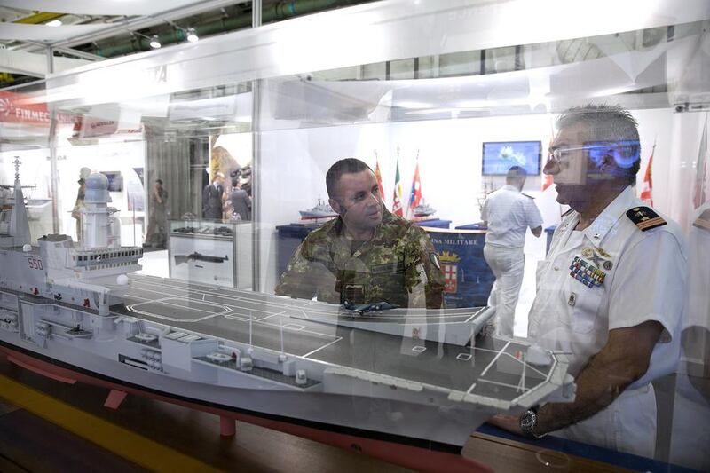 Visitors view a replica of the Italian aircraft carrier Cavour. Silvia Razgova / The National