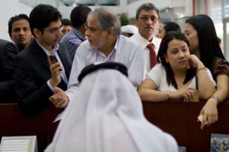 Dubai - October 28, 2008: People attempt to apply for the new ID card  at the Emirates Identity Authority at the Dubai Central Post Office. ( Philip Cheung / The National ) *** Local Caption ***  PC0033-IdCards.jpg