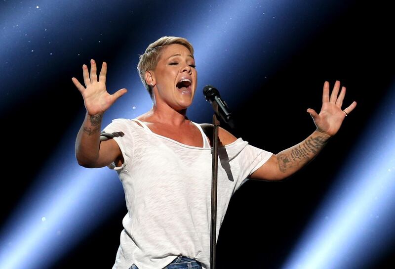 FILE - In this Jan. 28, 2018, file photo, Pink performs "Wild Hearts Can't Be Broken" at the 60th annual Grammy Awards at Madison Square Garden in New York.  Pink was admitted to a Sydney hospital on Monday, Aug. 6, with a virus, forcing her to postpone a second show, her promoter said. The singer's "Beautiful Trauma" world tour's first concert in Sydney was scheduled for last Friday, but she canceled that show on doctor's orders. She battled through a Saturday night show. (Photo by Matt Sayles/Invision/AP, File)