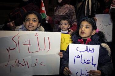 Children hold placards as they take part in a sit-in near the New Zealand Consulate against shooting at the Al Noor mosque in Christchurch, in Amman, Jordan, March 15, 2019. The placards read: 'We demand the execution of the murderer', 'God is greater than the unjust'. REUTERS/Muhammad Hamed