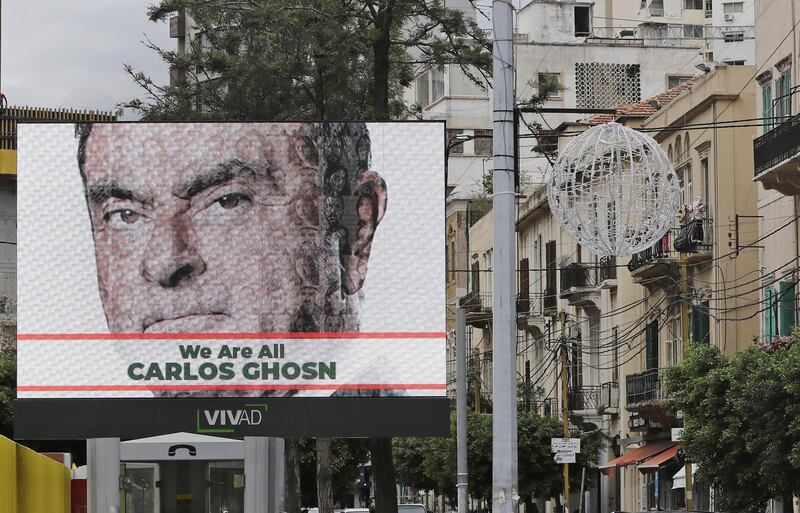 A portrait of ousted Nissan chairman Carlos Ghosn is seen on a publicity billboard in his support at a street in Beirut on December 6, 2018. - Ghosn, born in Brazil of Lebanese descent, was arrested on November 19, 2018 in Tokyo over alleged financial misconduct. He is facing further accusation of under-reporting his salary by about $35.5 million over the last three years. (Photo by JOSEPH EID / AFP)