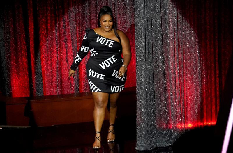 Lizzo appears on stage to accept the award for Top Song Sales Artist at the Billboard Music Awards wearing a black "vote" gown by Christian Siriano. Reuters
