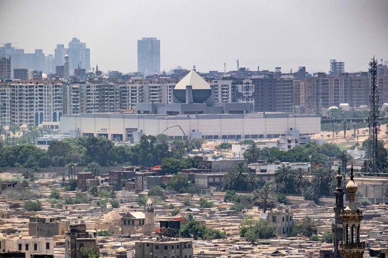 This picture taken on May 26, 2021 from the Cairo Citadel overlooking the Egyptian capital shows a view of the new National Museum of Egyptian Civilisation (NMEC), which currently houses a collection of mummies dating to the New Kingdom period of Ancient Egyptian history.  / AFP / Amir MAKAR

