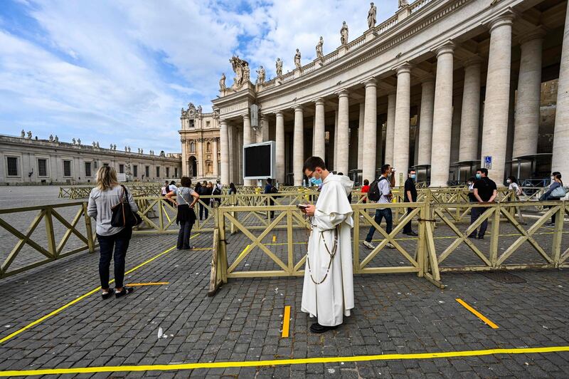 People line up in respect of security distancing to access St. Peter's Basilica in The Vatican during the lockdown aimed at curbing the spread of the COVID-19 infection, caused by the novel coronavirus.   AFP