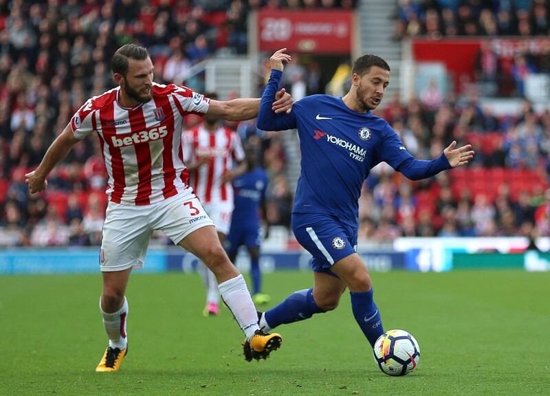 Chelsea's Eden Hazard, right, and Stoke City's Erik Pieters battle for the ball during the English Premier League soccer match between Stoke City and Chelsea at the bet365 Stadium, Stoke-on-Trent, England, Saturday, Sept. 23, 2017. (Nigel French/PA via AP)