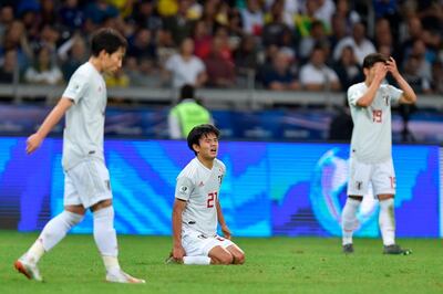Japan's Takefusa Kubo, centre, looks dejected after a 1-1 draw against Ecuador saw both teams exit the 2019 Copa America. AFP