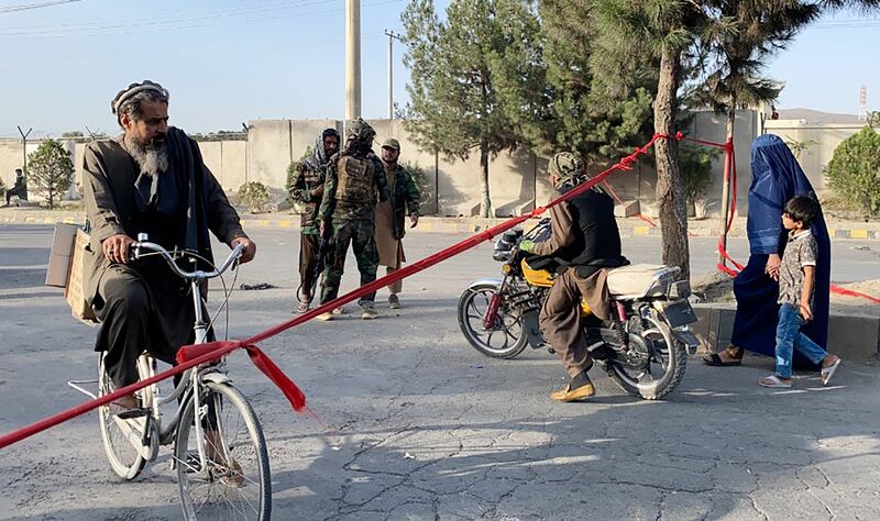 Taliban fighters stand guard outside the Hamid Karzai International Airport in Kabul.  EPA