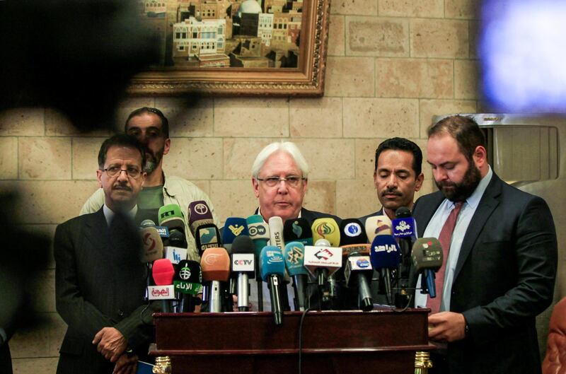 Martin Griffiths (C), the UN special envoy for Yemen, gives a press conference in the Yemeni capital Sanaa's international airport prior to his departure on July 4, 2018, accompanied by Faisal Amin Abu-Rass (L), the under-secretary of Huthi rebels' foreign ministry.  / AFP / MOHAMMED HUWAIS
