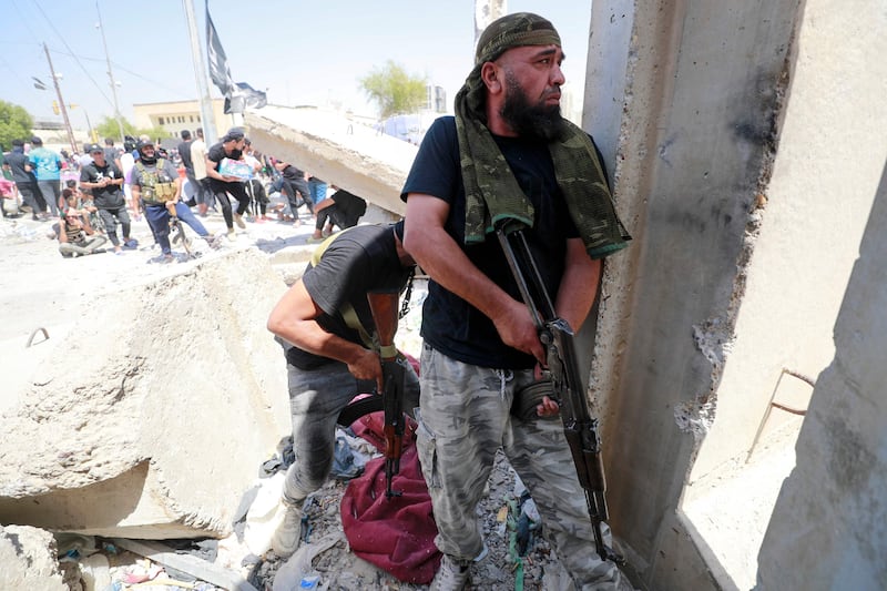 Armed members of Saraya Al Salam, the military wing affiliated with Shiite cleric Moqtada Al Sadr. AFP