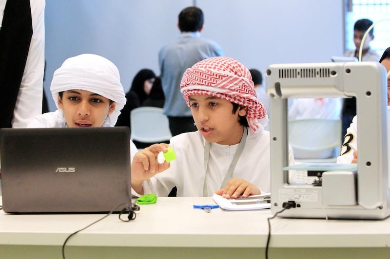 Pupils from schools in Abu Dhabi learn to use a 3-D printer during the Tech Quest camp at the Masdar Institute. Christopher Pike / The National