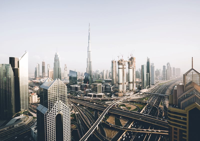 A birds-eye-view shot of the Sheikh Zayed Road and the Burj Khalifa in Dubai.