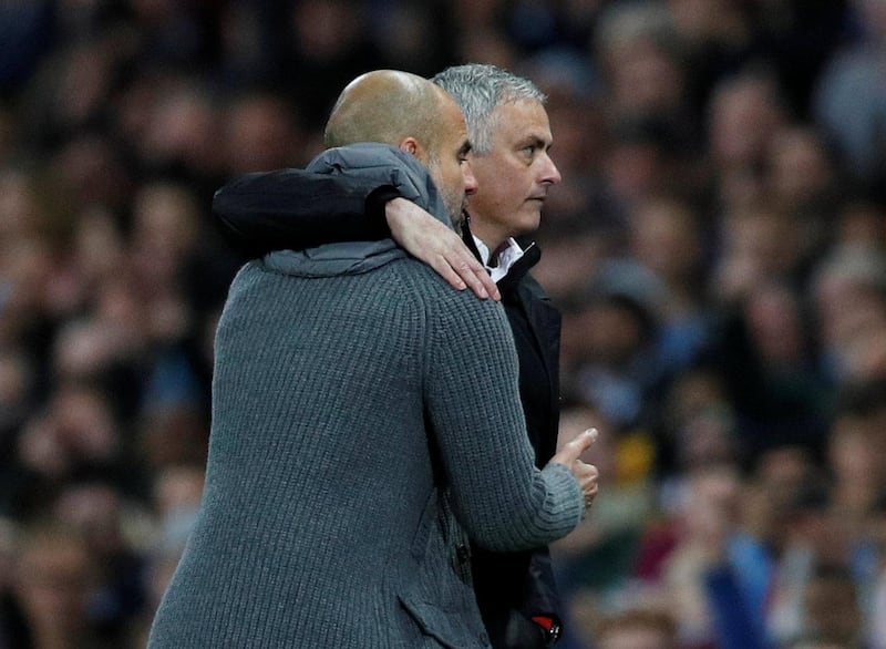 Manchester City manager Pep Guardiola with Manchester United manager Jose Mourinho after the match. Reuters