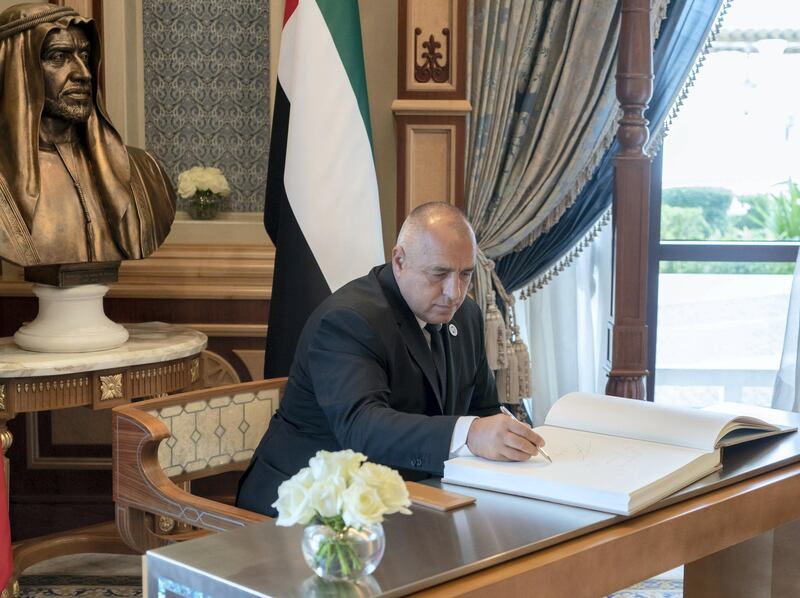ABU DHABI, UNITED ARAB EMIRATES - October 21, 2018: HE Boyko Borisov, Prime Minister of Bulgaria (C), signs a guest book during a reception held at the Presidential Palace.

( Rashed Al Mansoori / Crown Prince Court - Abu Dhabi )
---