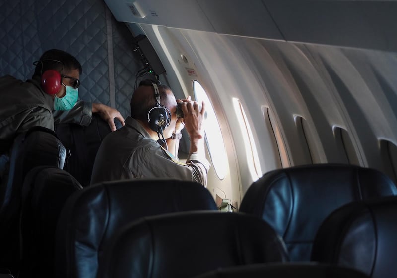 Members of Indonesian Navy's maritime patrol aircraft of 800 Air Squadron of the 2nd Air Wing of Naval Aviation Center (PUSPENERBAL) use binoculars during a search mission for KRI Nanggala. EPA