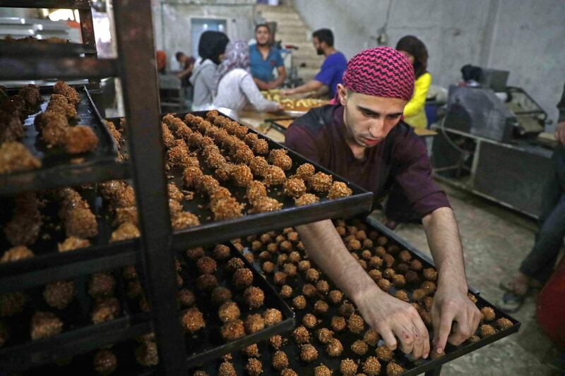 Traditional sweets being prepared at a bakery run by displaced Syrians in the town of Dana, east of the Turkish-Syrian border in the northwestern Idlib province. Aaref Watad / AFP