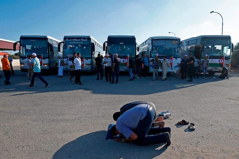 Palestinian pilgrims pray as they arrive at the Rafah border crossing between Egypt and the southern Gaza Strip, ahead of their departure for the annual Hajj pilgrimage. AFP