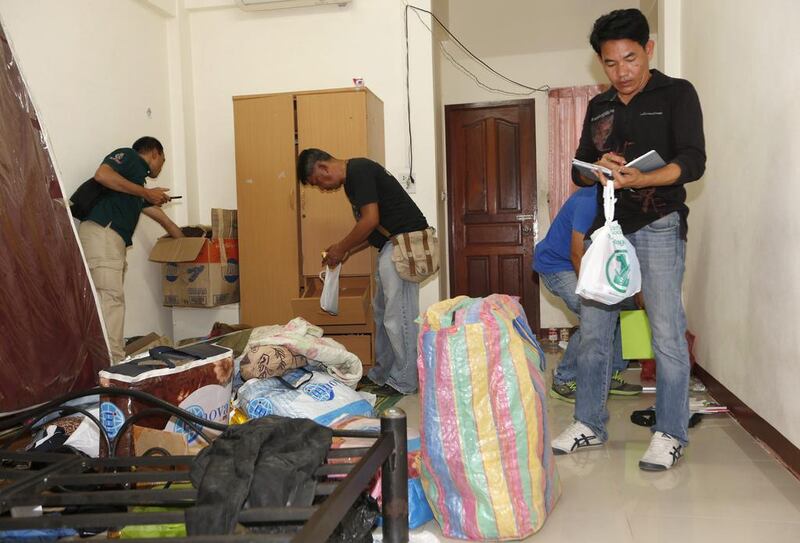 Policemen search a room on the outskirts of Bangkok that is believed to have been rented by the suspect. Rungroj Yongrit / AFP